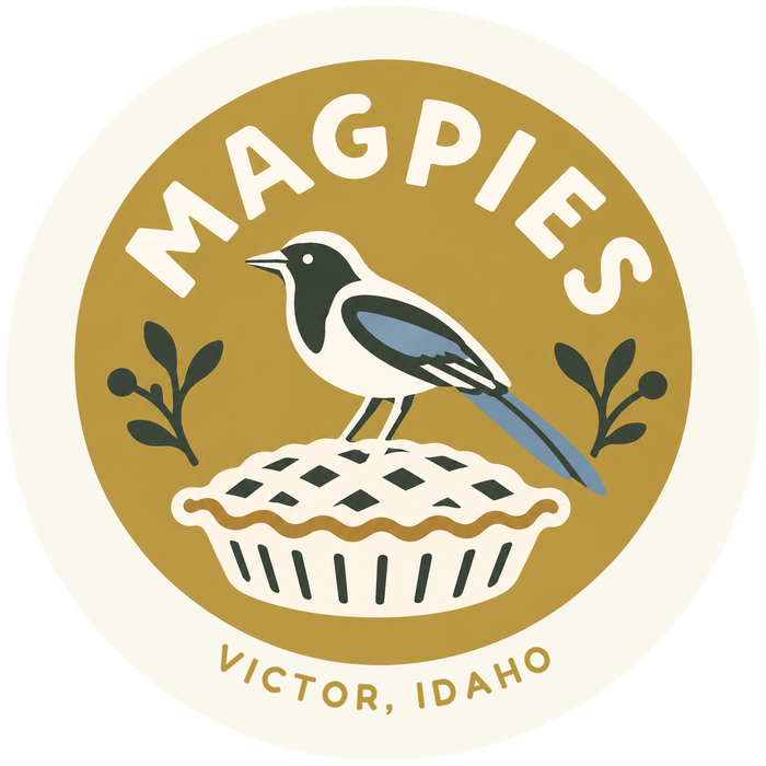 Magpies logo: a magpie standing on a lattice pie, Victor, Idaho
